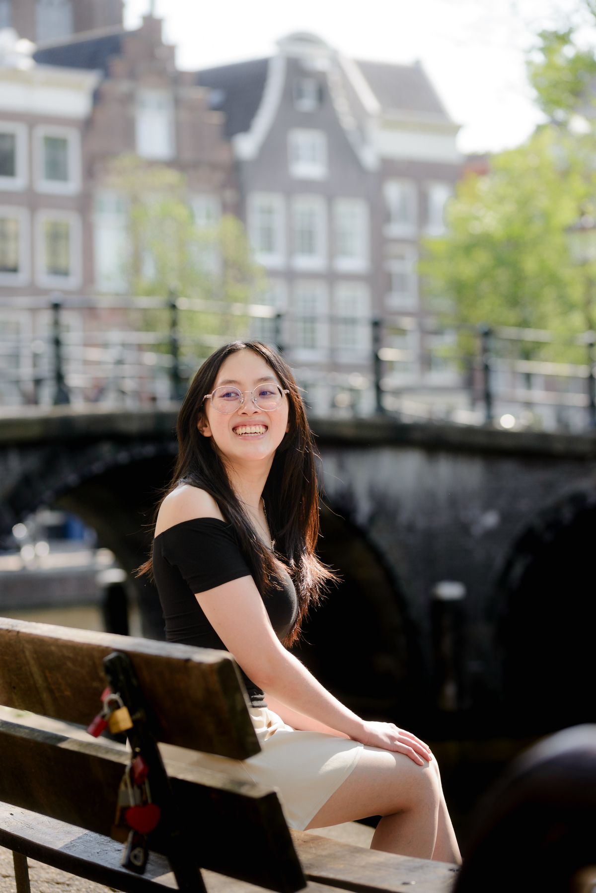 Woman seated beside an Amsterdam canal during her first solo photo session