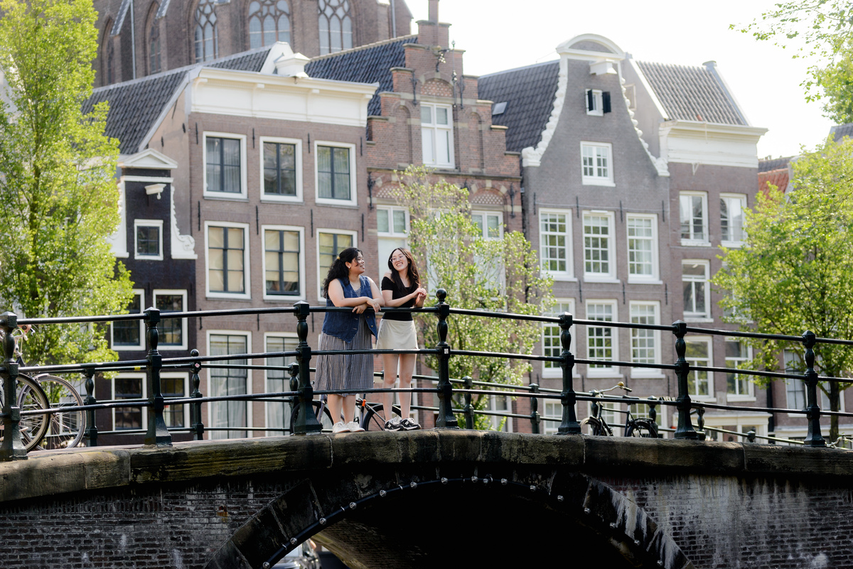 Gift giver and friend walking beside the canal after revealing the surprise session