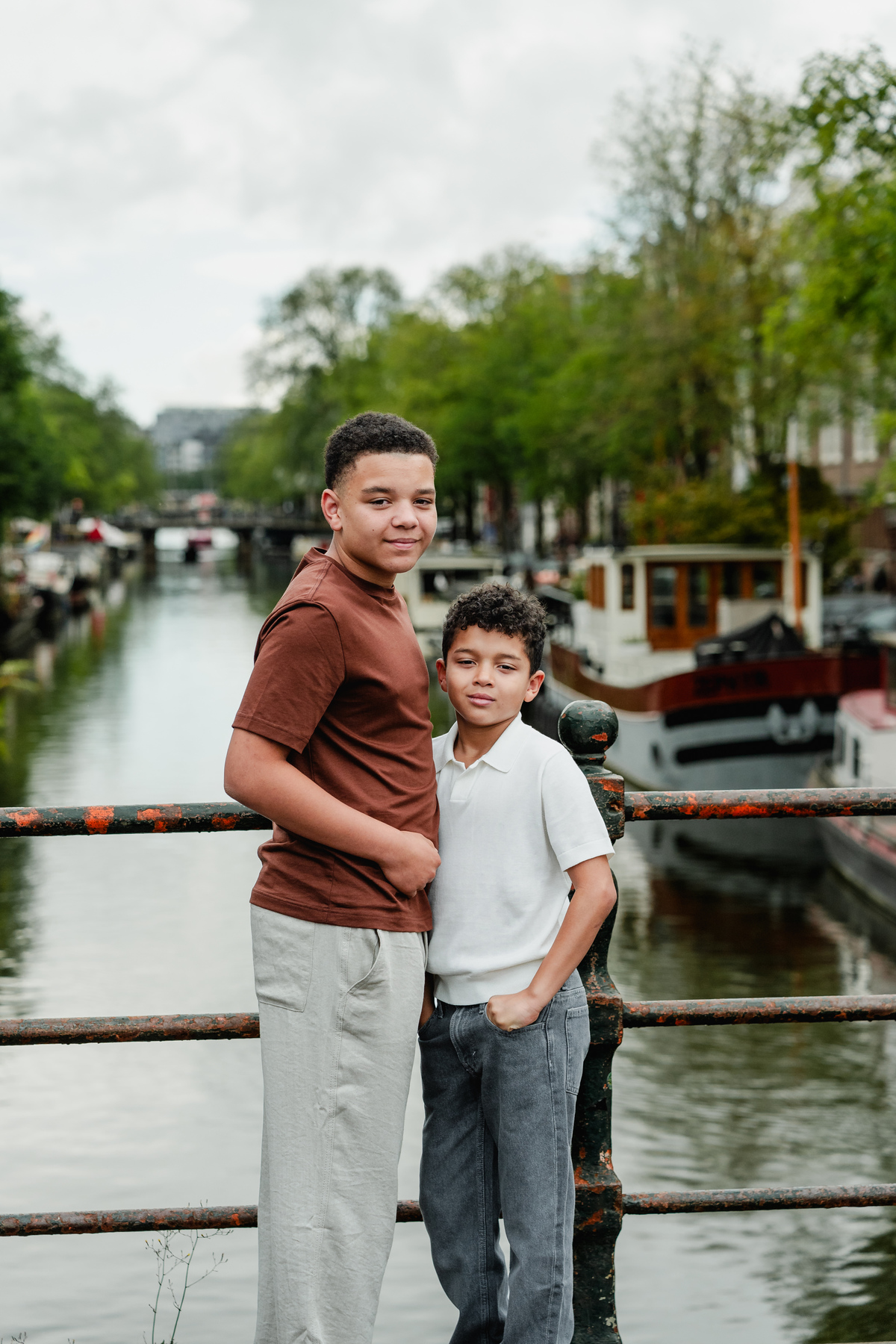 Two brothers posing and smiling together in the Jordaan, Amsterdam.Two brothers posing and smiling together in the Jordaan, Amsterdam.