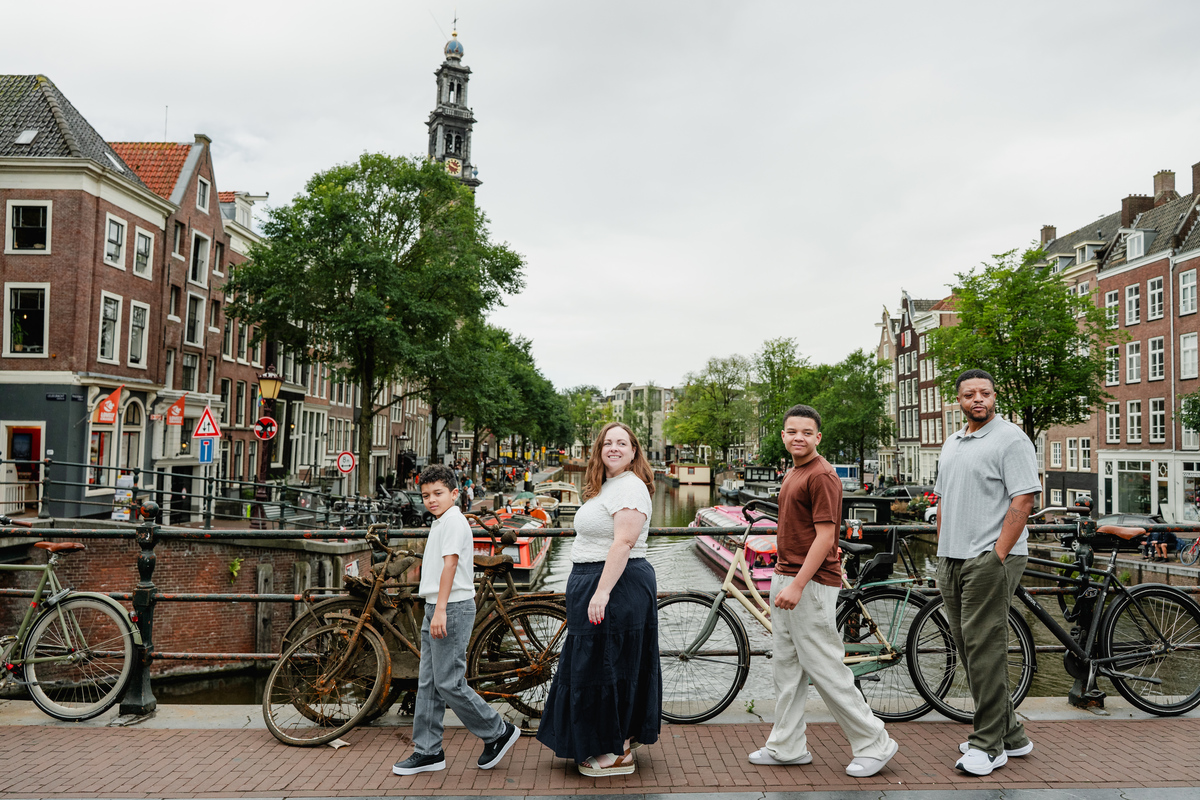 Family of four walking together through the streets of the Jordaan in Amsterdam.