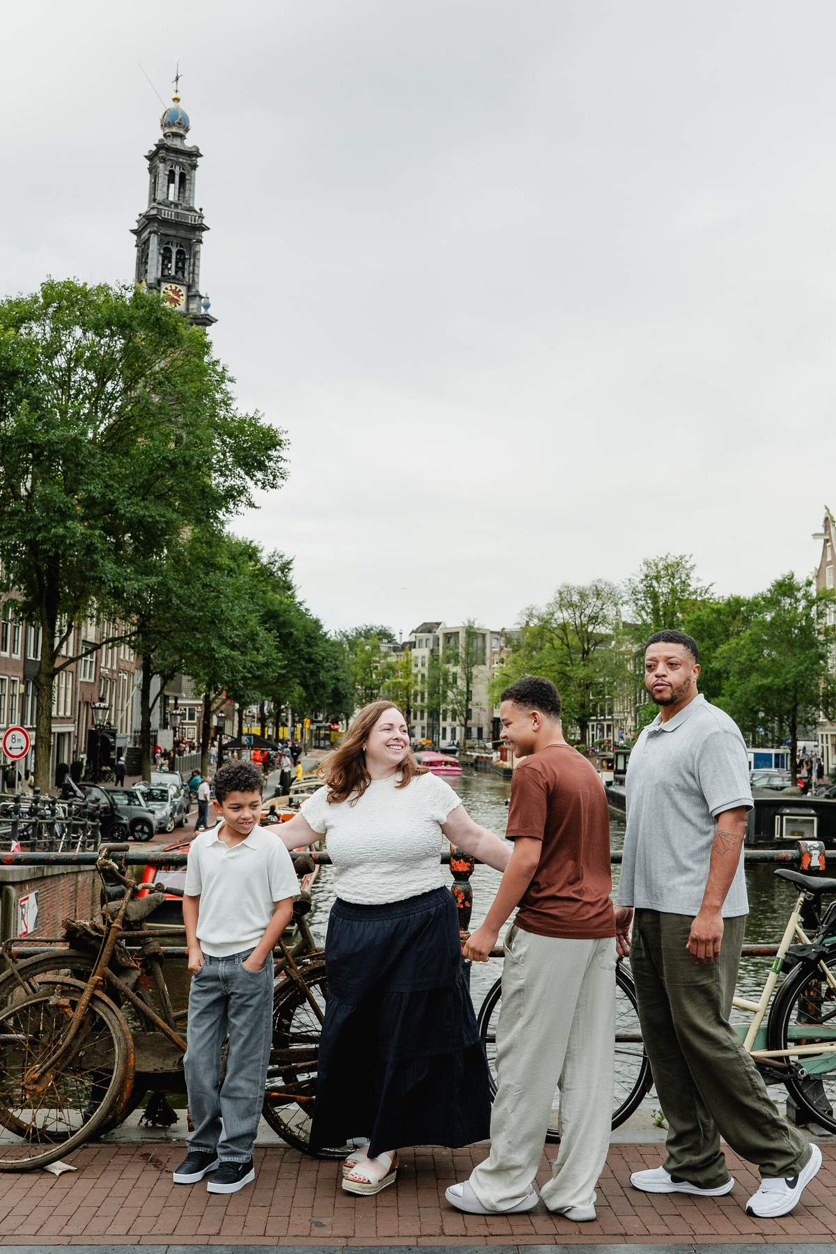 Family of four walking together through the streets of the Jordaan in Amsterdam.