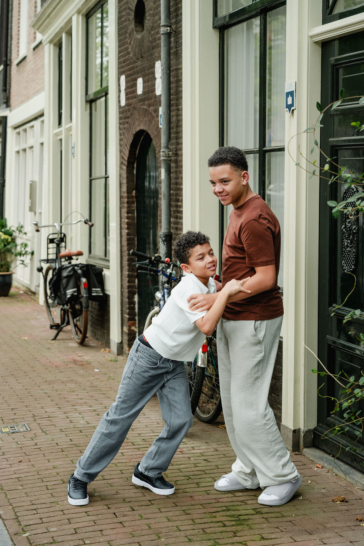 Two brothers playing together on a street in Amsterdam’s Jordaan neighbourhood.