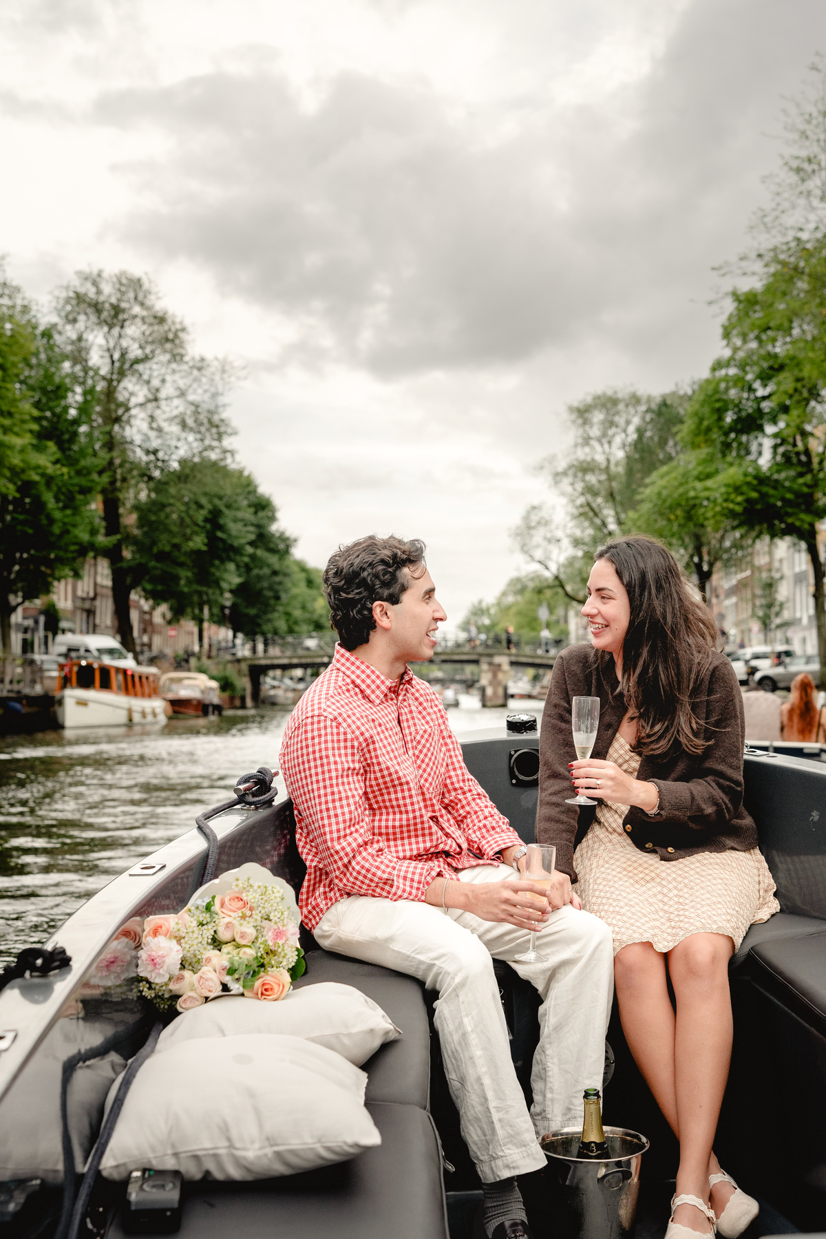 Couple enjoying a quiet canal ride after their proposal.

