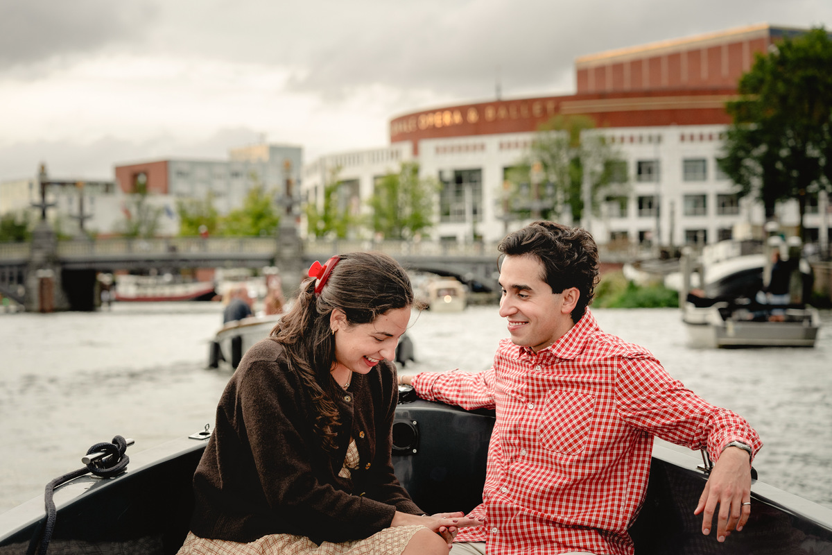 Relaxed engagement portrait on a private boat in Amsterdam.