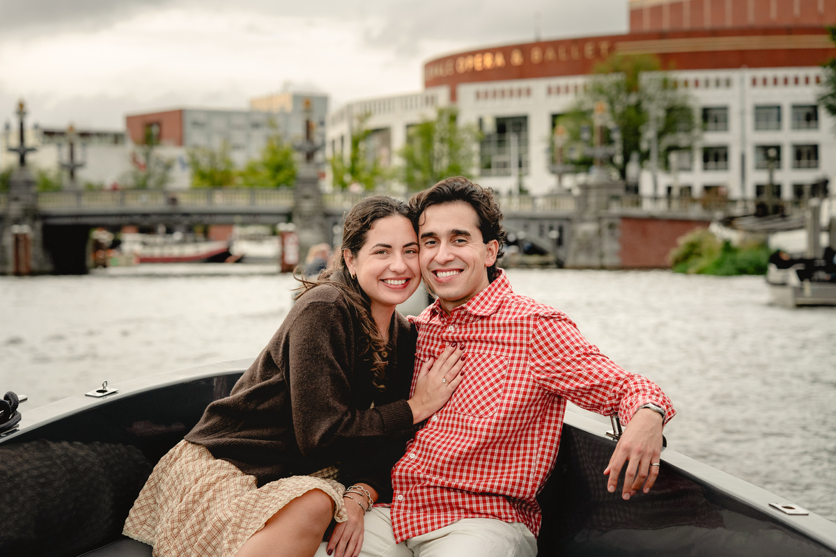 Newly engaged couple sitting together during their canal boat ride.