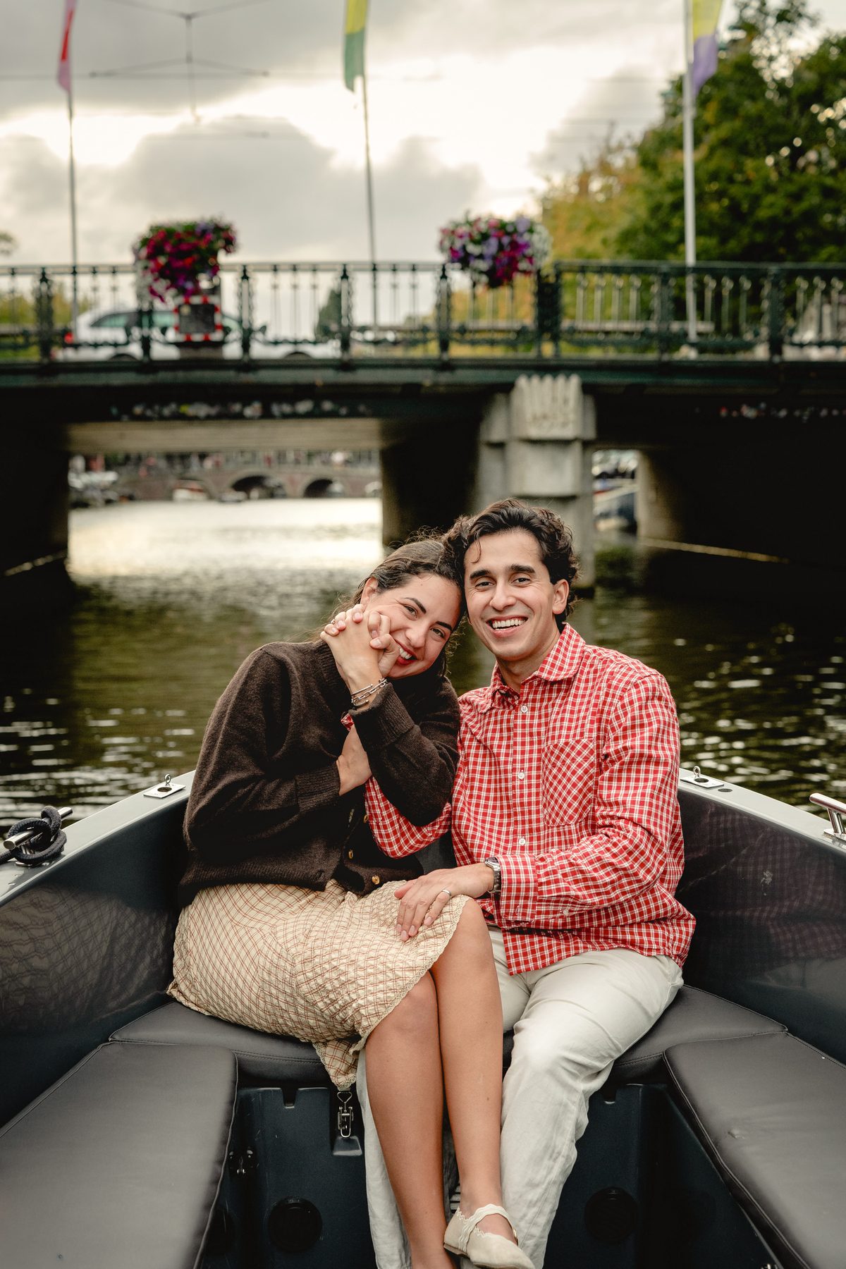 Portrait of a newly engaged couple on a canal boat in Amsterdam.