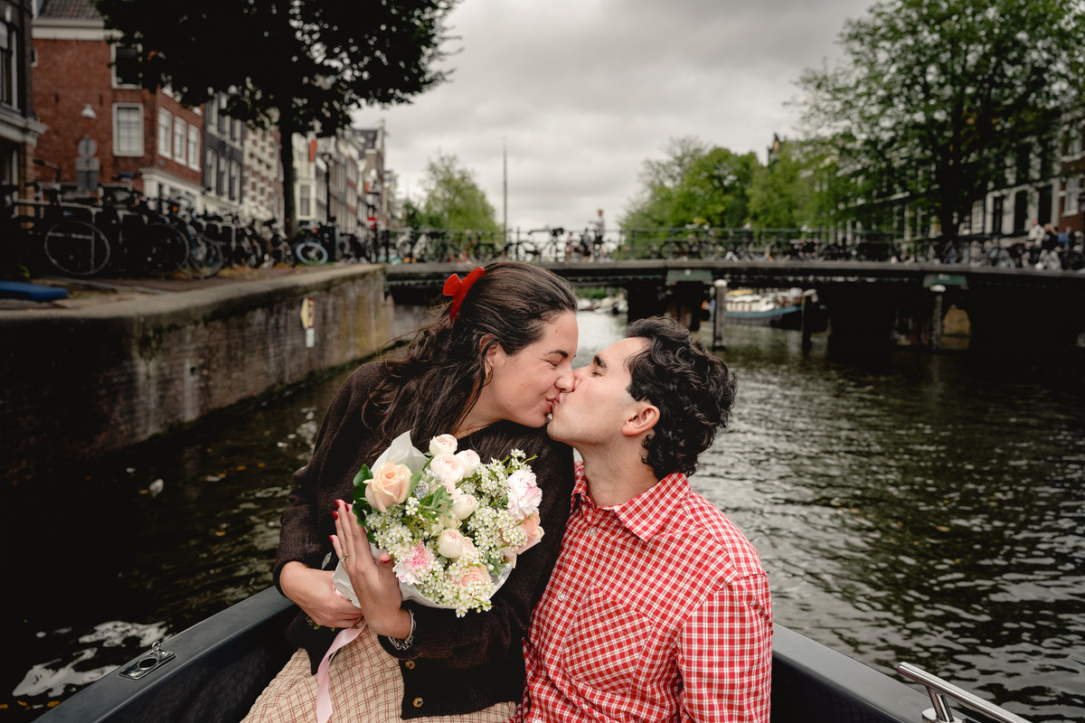 Engaged couple with flowers after a private boat proposal.