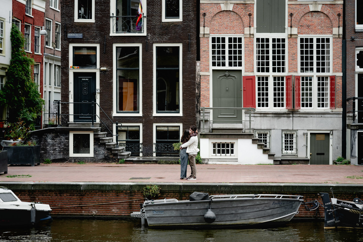 Couple celebrating their engagement beside an Amsterdam canal.