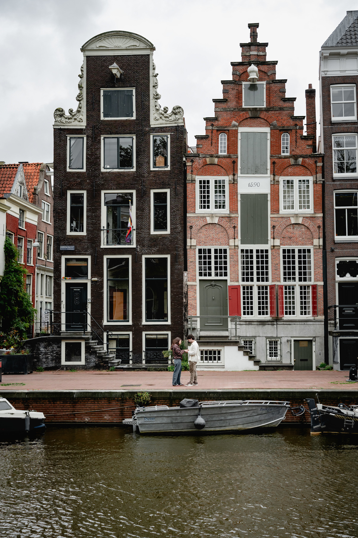 Couple celebrating their engagement beside an Amsterdam canal.