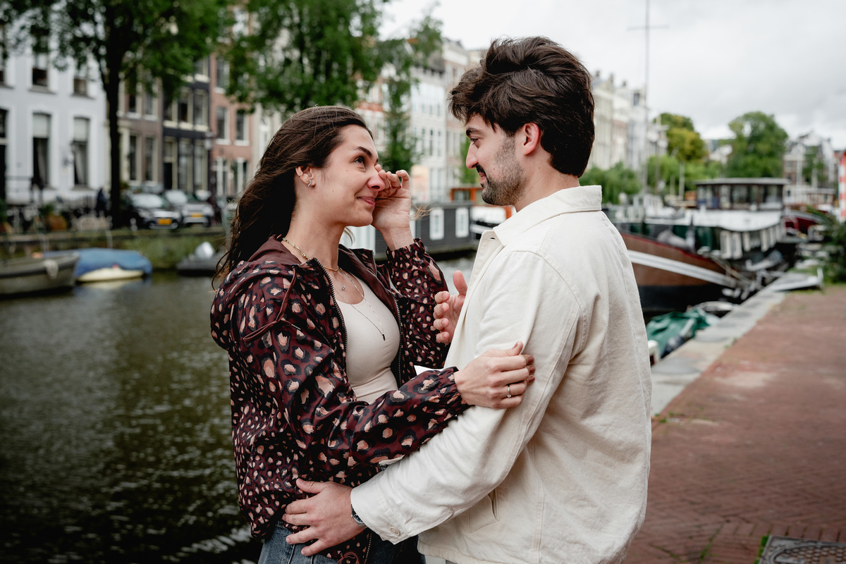 Couple embracing after their Amsterdam engagement proposal.