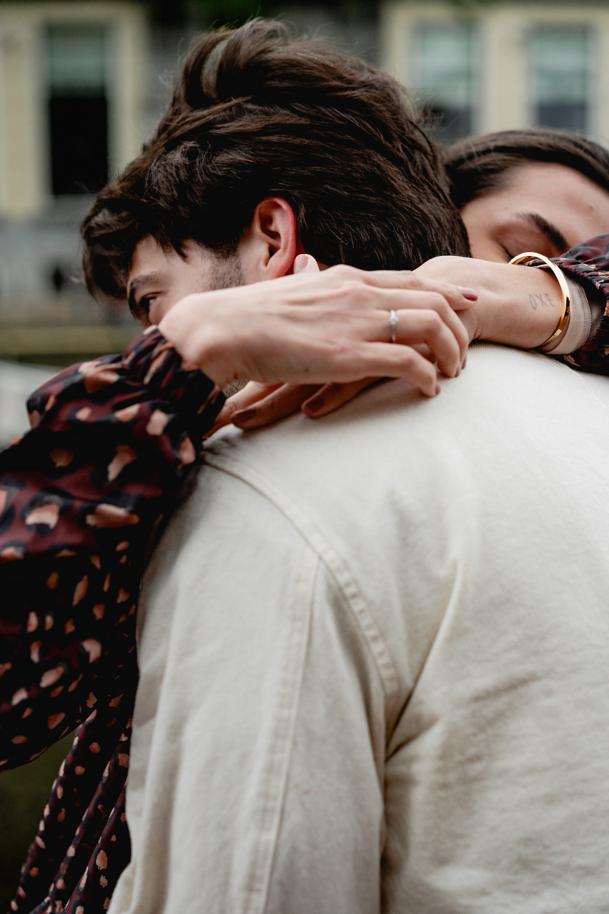 Close-up of the couple holding each other after the proposal.