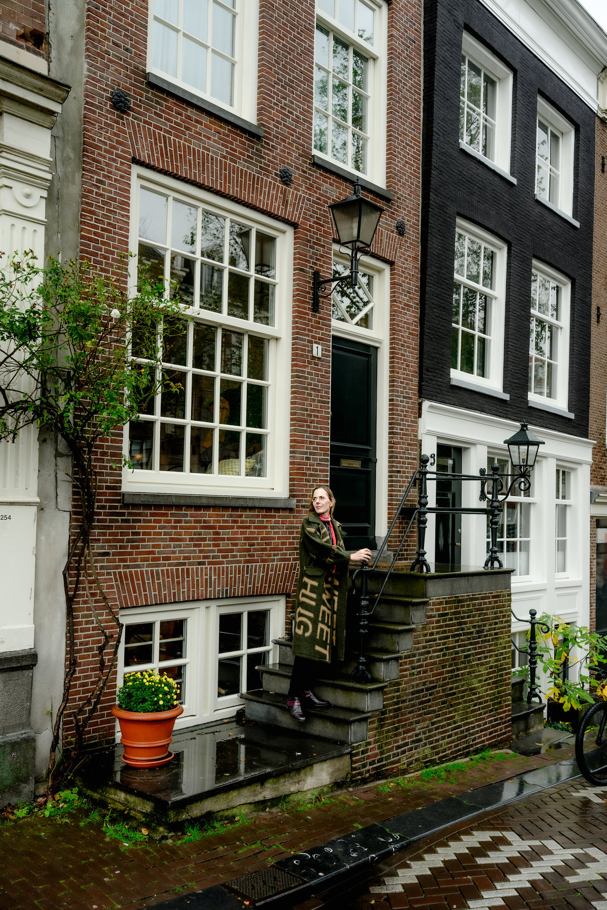 Historic Amsterdam canal house and street photographed during a solo portrait session.