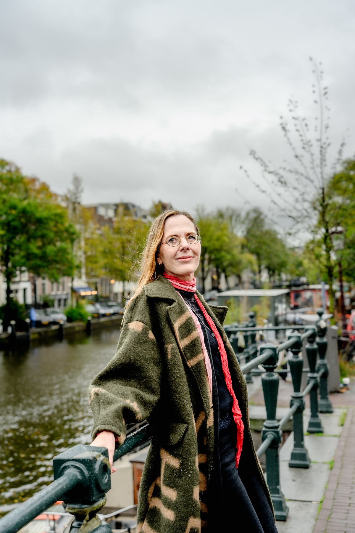 Woman looking over an Amsterdam canal during a solo photo session.