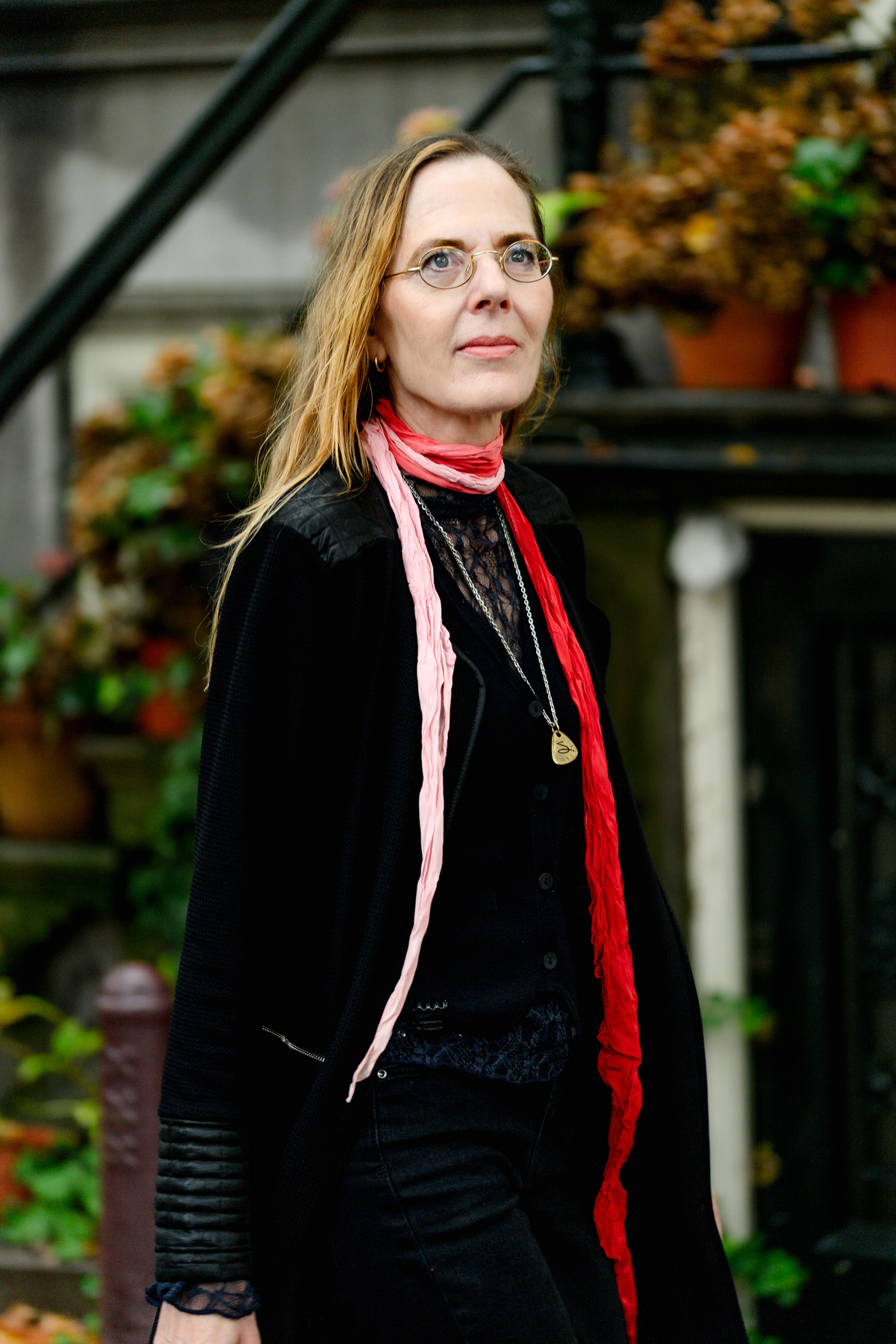 Close portrait of a woman in a red scarf during a solo photo session in Amsterdam.