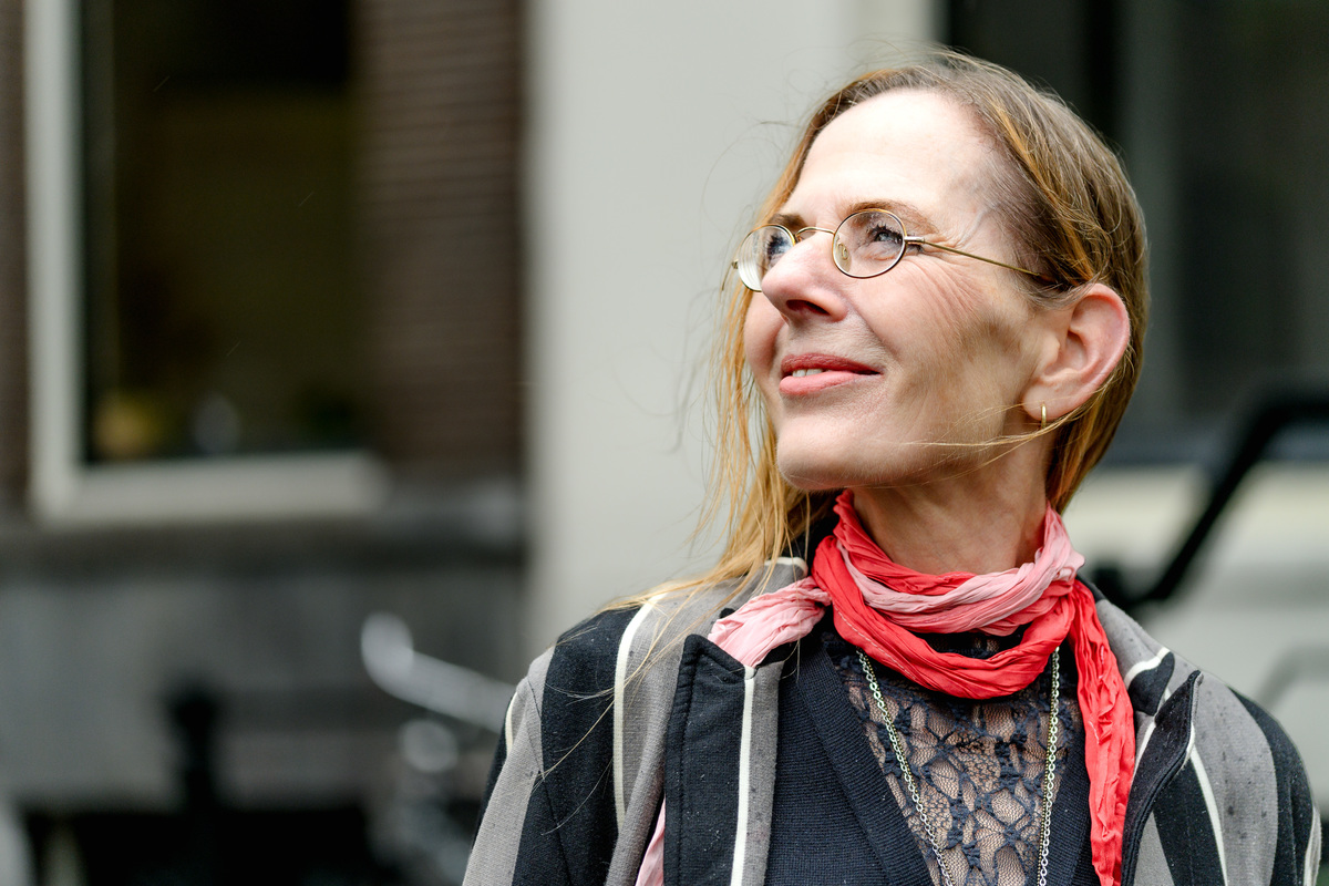 Close portrait of a woman smiling during a solo Amsterdam photo session.