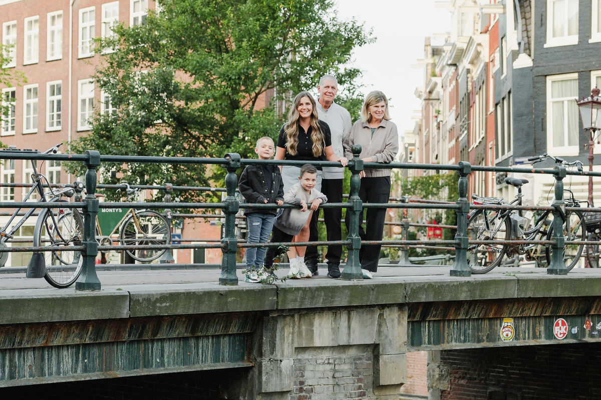 Grandparents, parents and children together on an Amsterdam bridge.