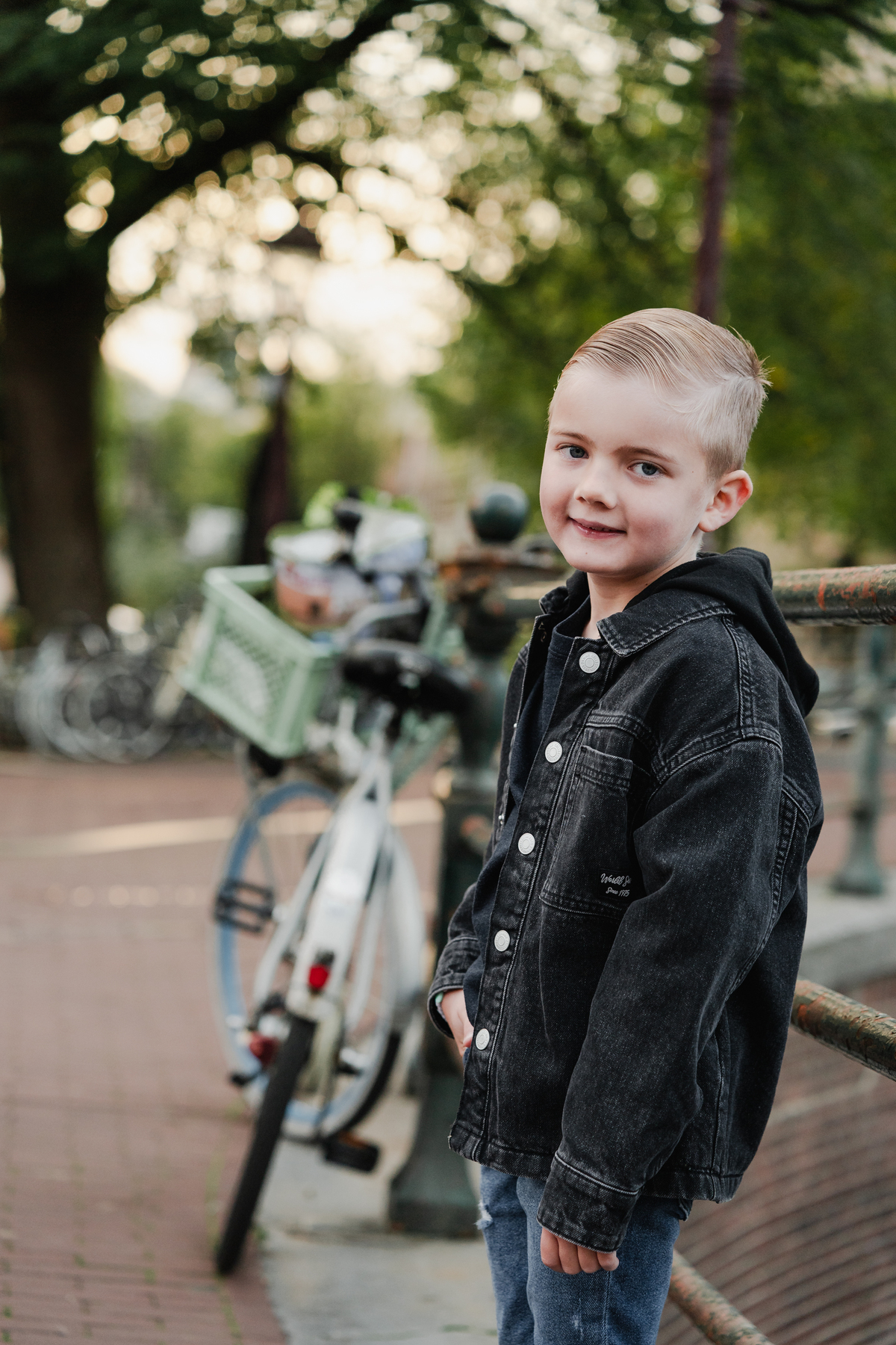 Portrait of a child beside bicycles in the Jordaan.