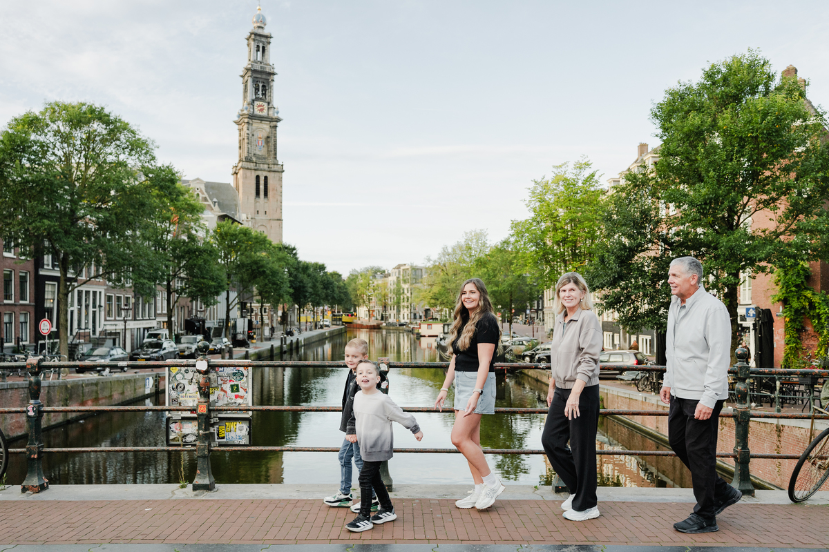 Family walking together beside an Amsterdam canal.