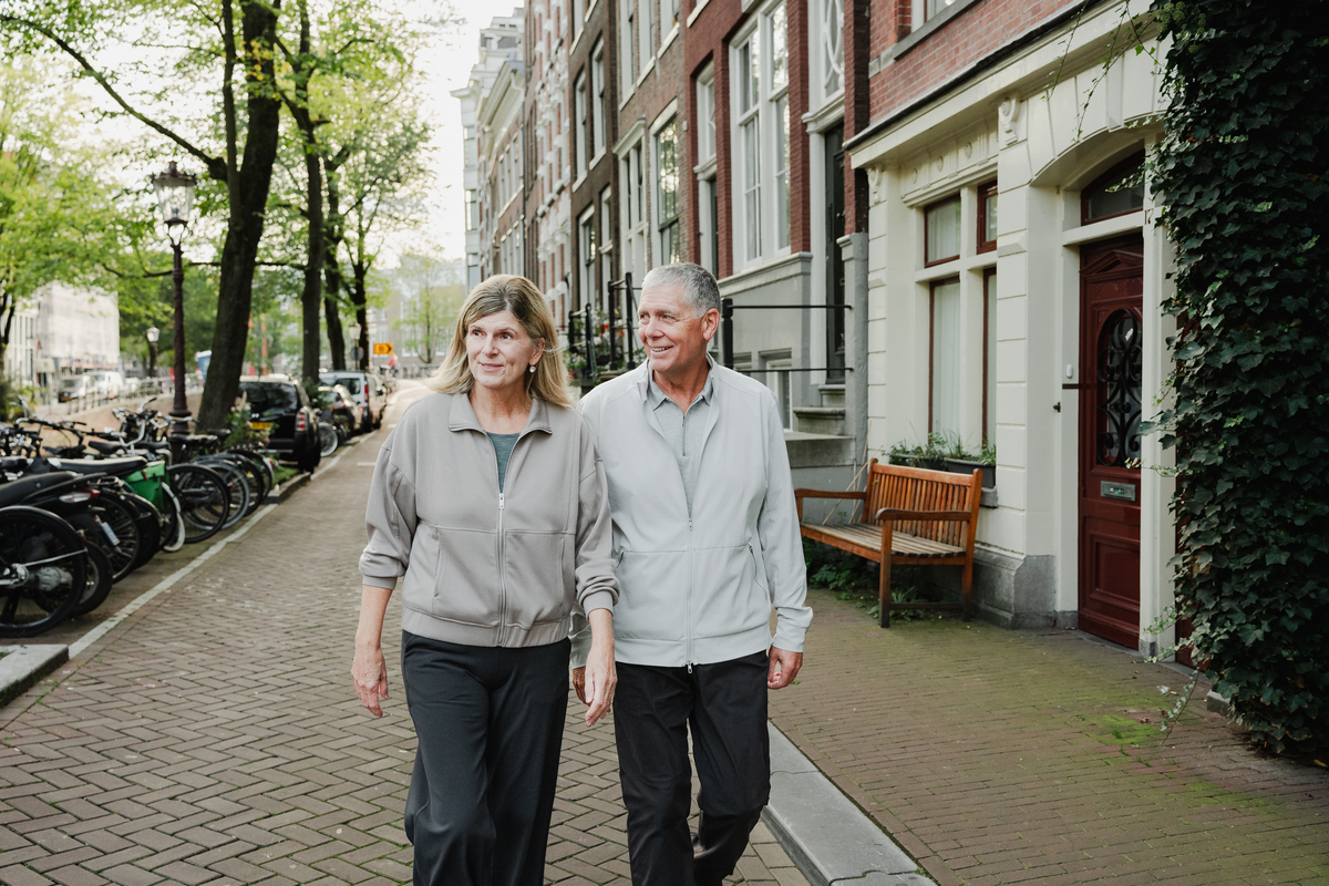 Portrait of grandparents walking together along an Amsterdam street.