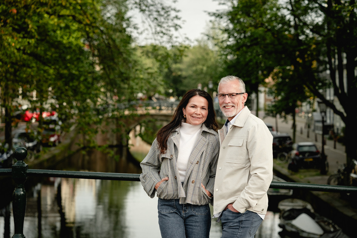 Close portrait of a couple standing together by the canal in Amsterdam.