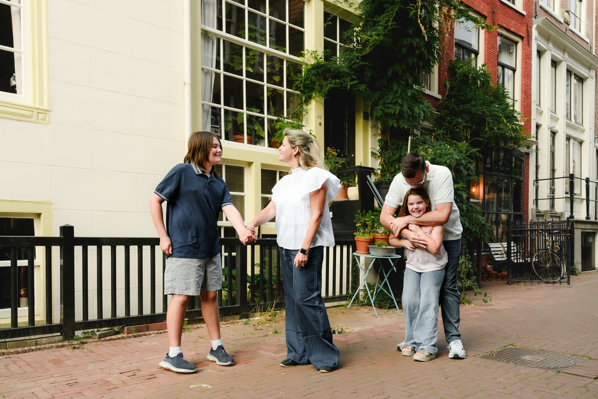 Family standing together on a residential Amsterdam street.