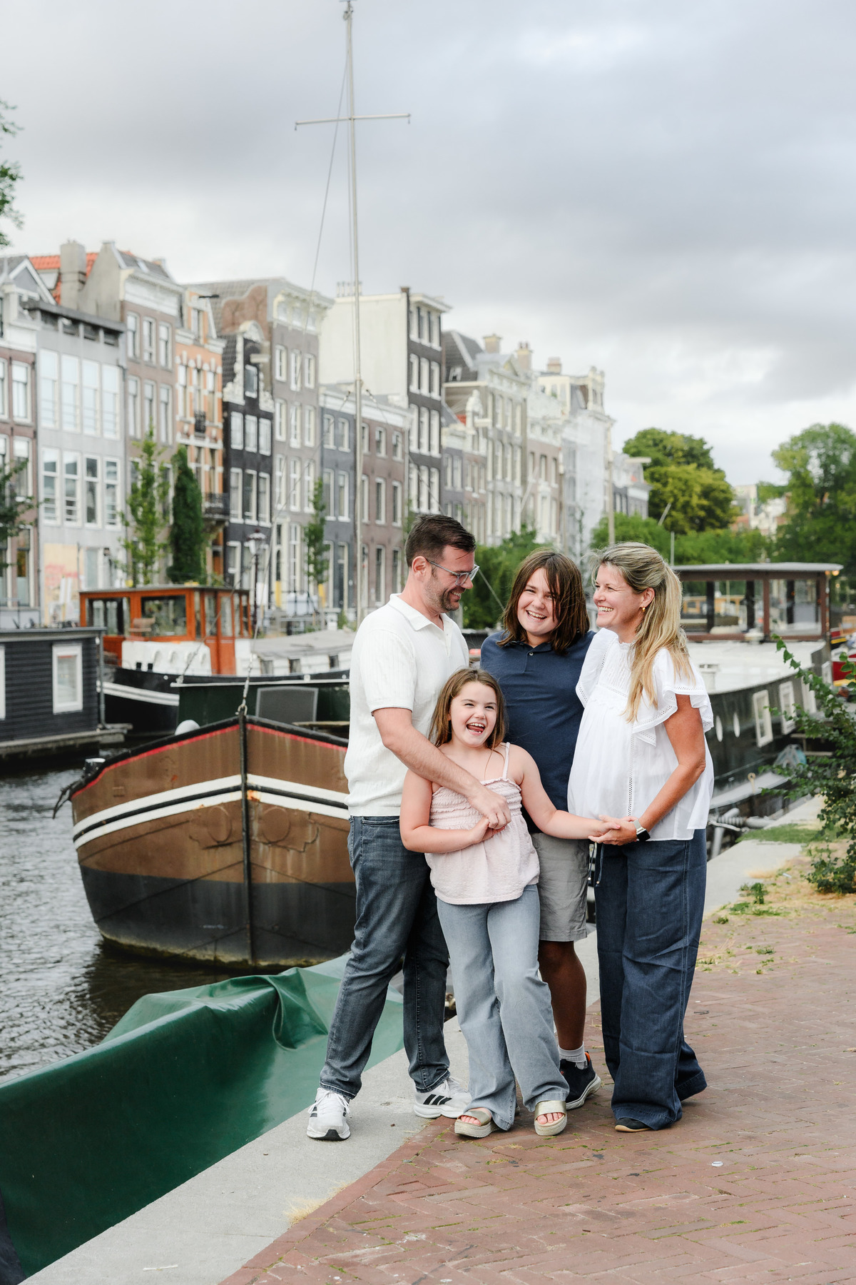 Family portrait beside the canal during a relaxed Amsterdam photo session.