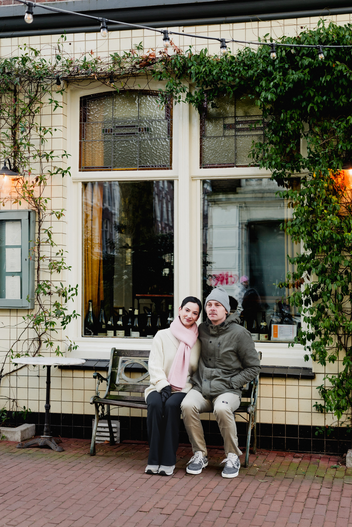 Couple sitting together outside an Amsterdam canal house.