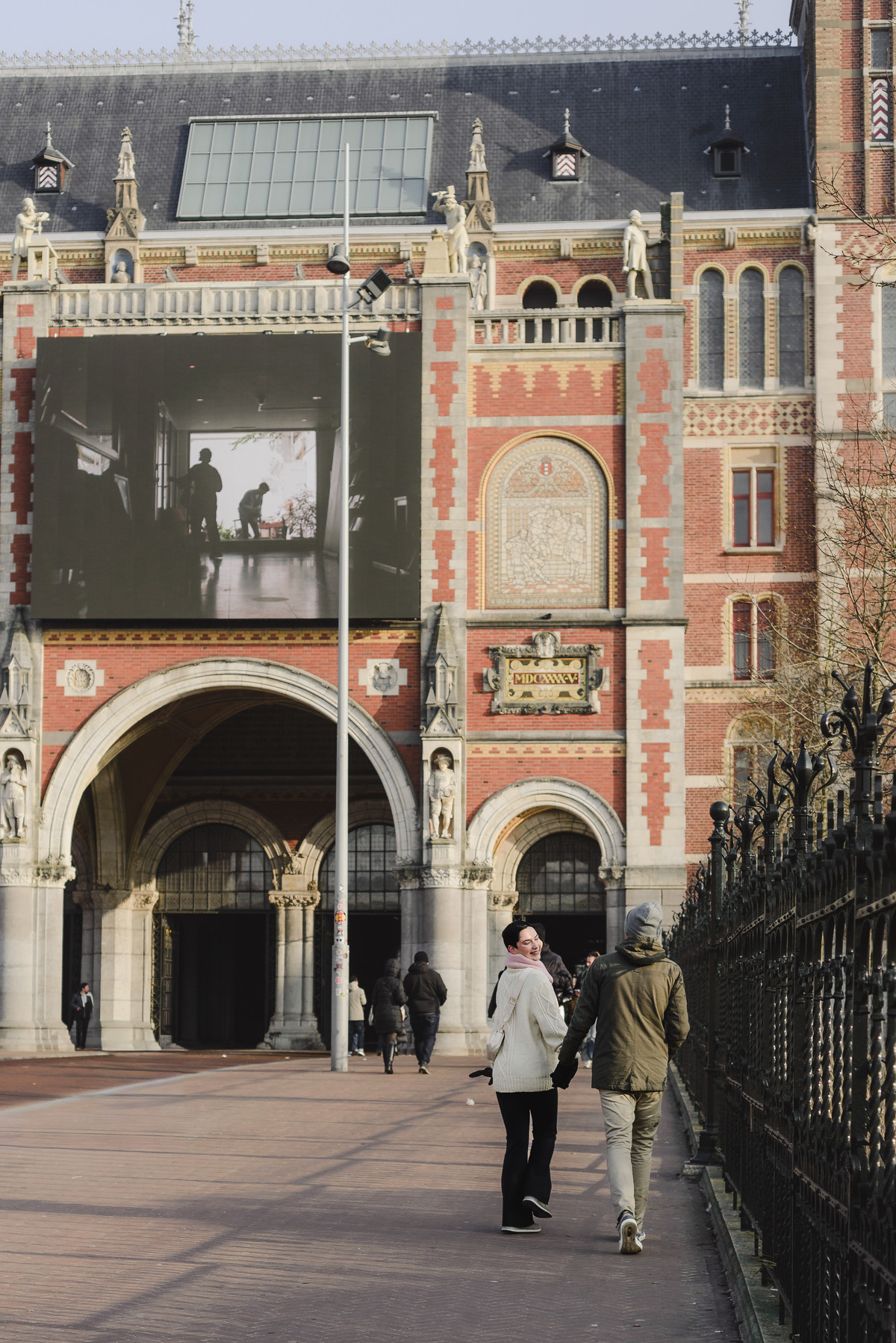 Couple standing together in front of the Rijksmuseum in Amsterdam.