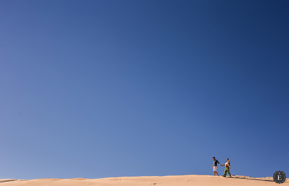 casal andando nas dunas de Florianópolis em ensaio de fotos