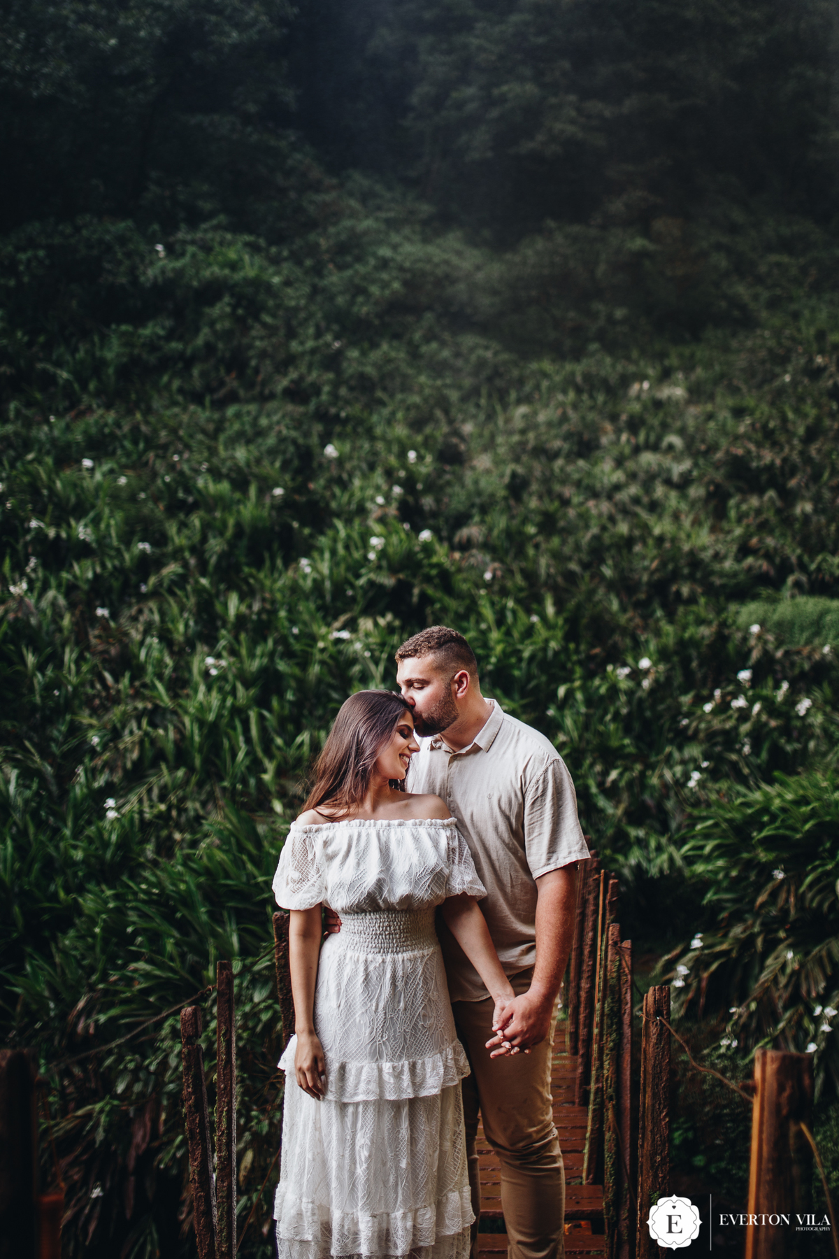 noivo beijando testa de sua noiva em sessão de fotos