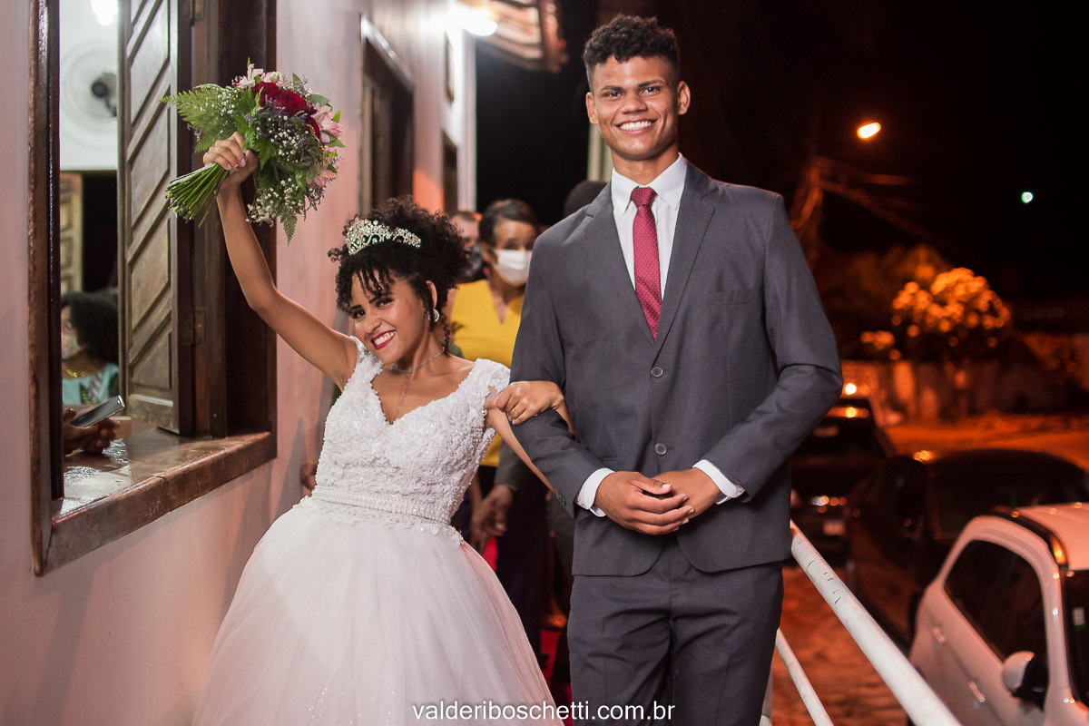Foto dos noivos felizes na saída do casamento com o buquê de flores na mão Foto dos noivos Cris e Ediney trocando alianças no casamento realizado na Igreja Maranata em Nova Lidice - Medeiros Neto - BA
Fotografia Valderi Boschetti
