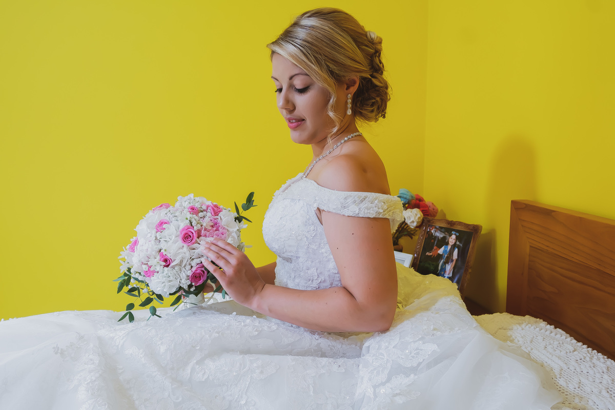 Noiva Andreia a olhar para o ramo