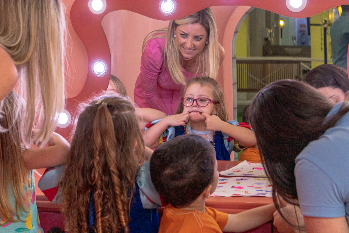 menina se olhando noespelho e fazendo caretas