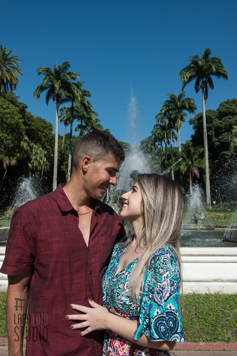 Casal com olhar apaixonado com chafariz ao fundo no ensaio pré casamento no Palácio Guanabara.
