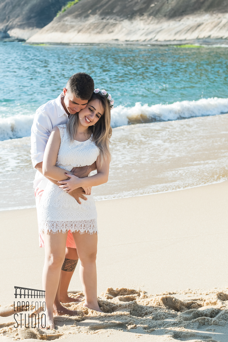 Noivo beija o pescoço da noiva no ensaio pré na praia vermelha