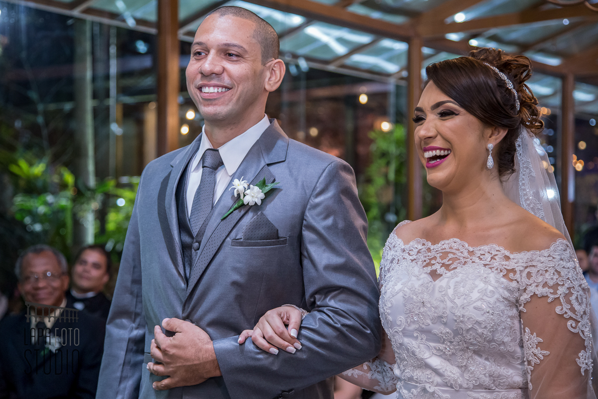 Noivos sorriem durante cerimônia no espaço jardins do Vale dos Sonhos