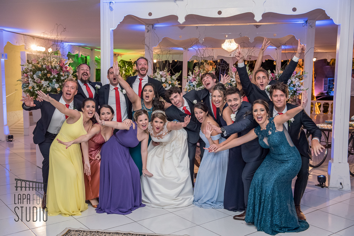 Padrinhos e madrinhas comemoram com os noivos numa foto divertida no dia do casamento