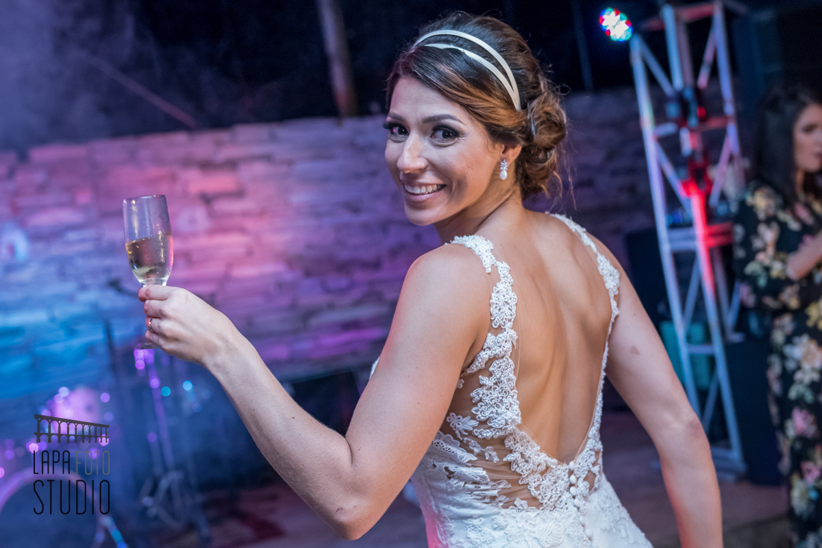 Noiva de costas oferece um brinde na Casa do Flamboyant