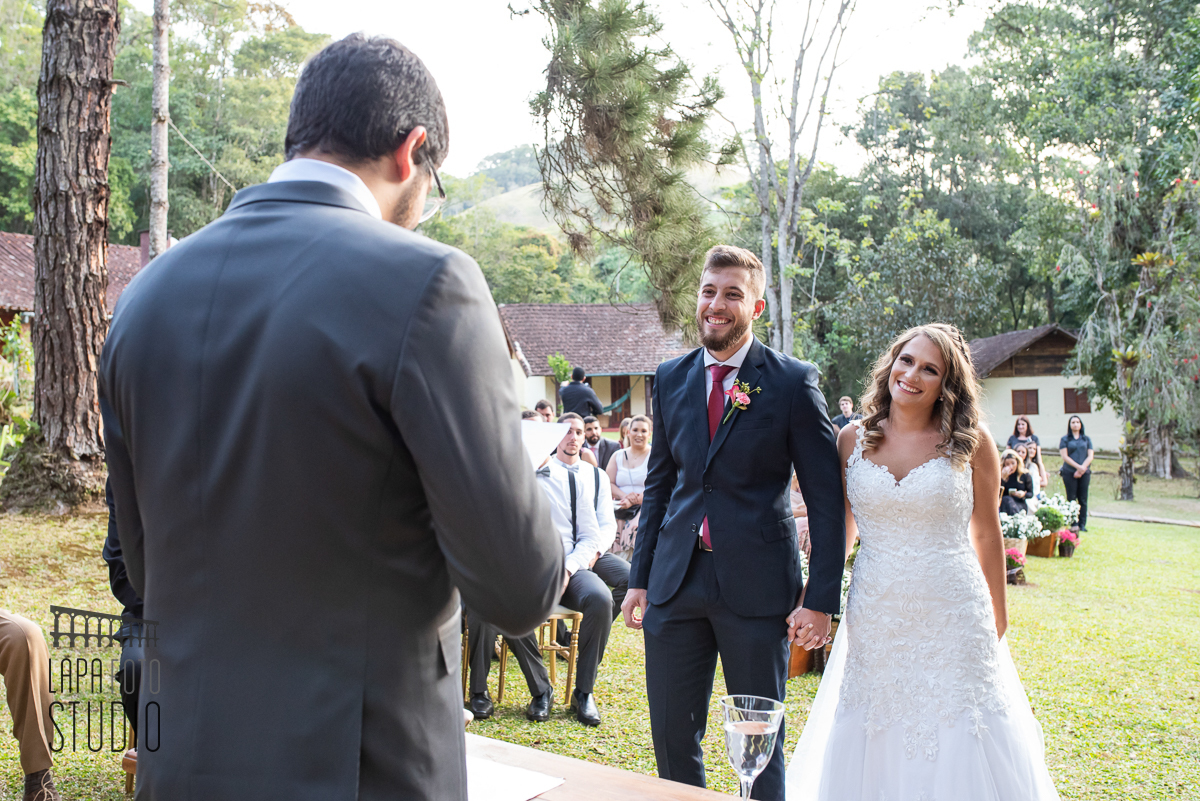 Noivos sorrindo no altar durante casamento em visconde de mauá