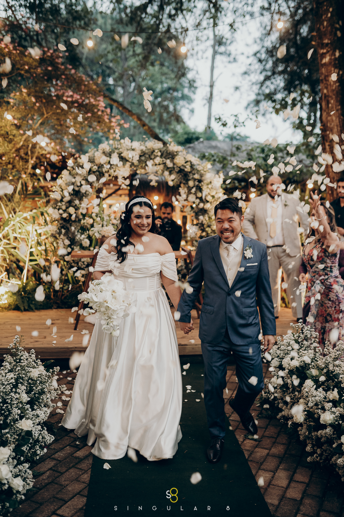 fotografia da saída dos noivos com pétalas de casamento no pôr do sol mairiporã rancho santa maria