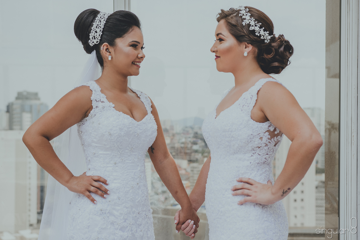 Noivas casando juntas com coque e tiara