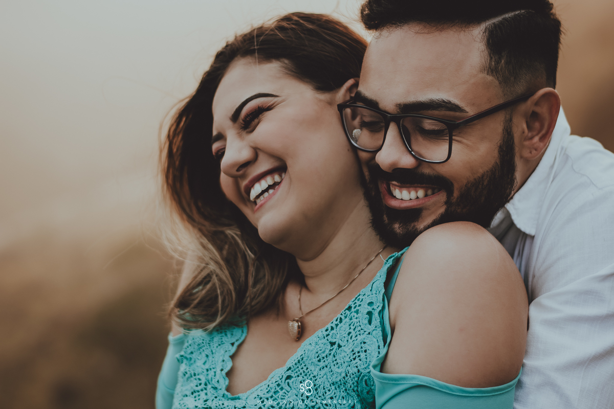 Fotografia de casal sorrindo em ensaio pré wedding no pico do olho d'agua em Mairiporã no amanhecer