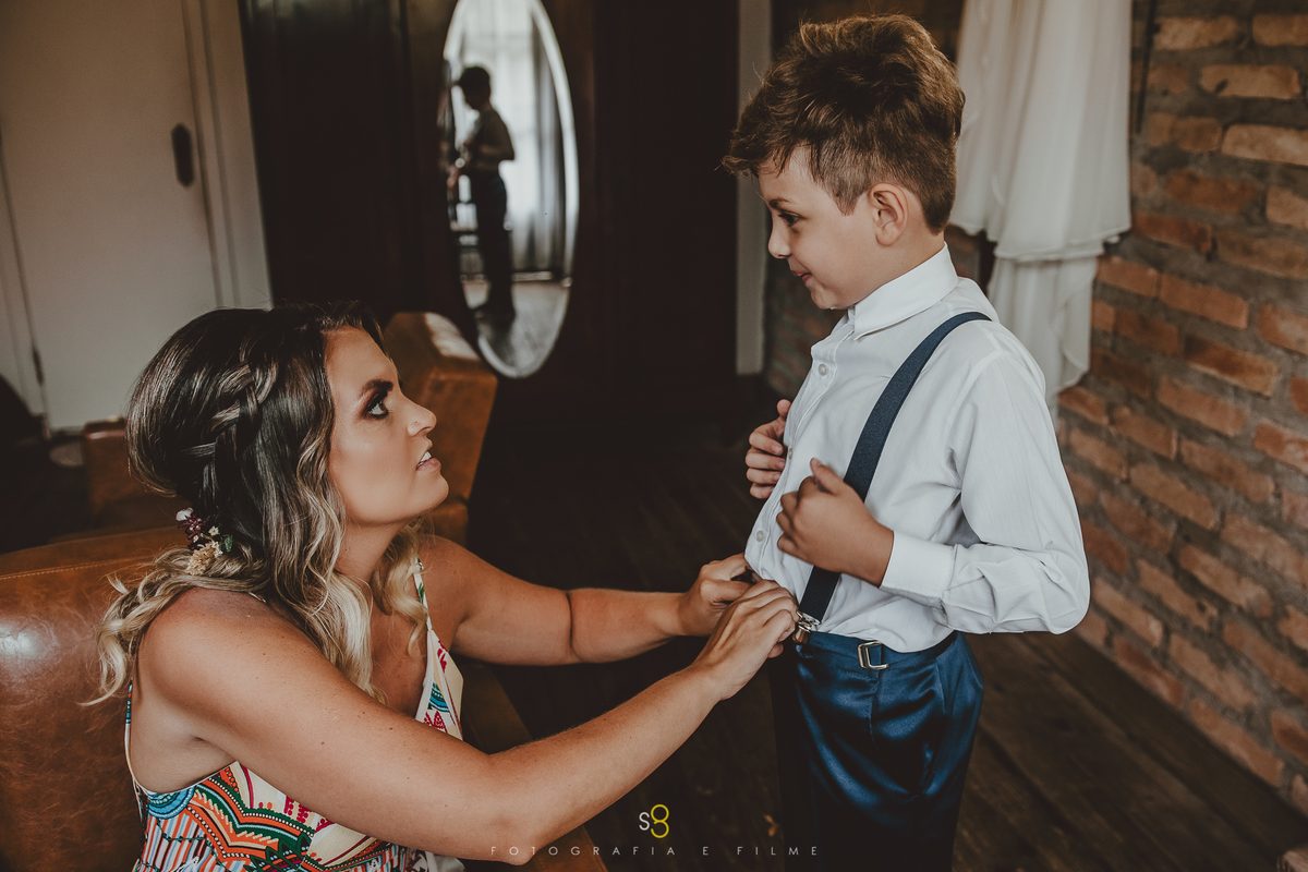 Noiva arrumando o filho em elopment wedding na pandemia do corona vírus
