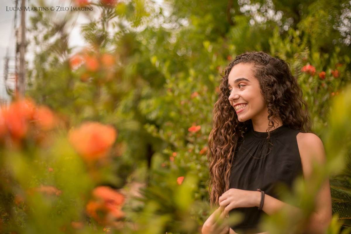 Debutante sorrindo em um campo de flores