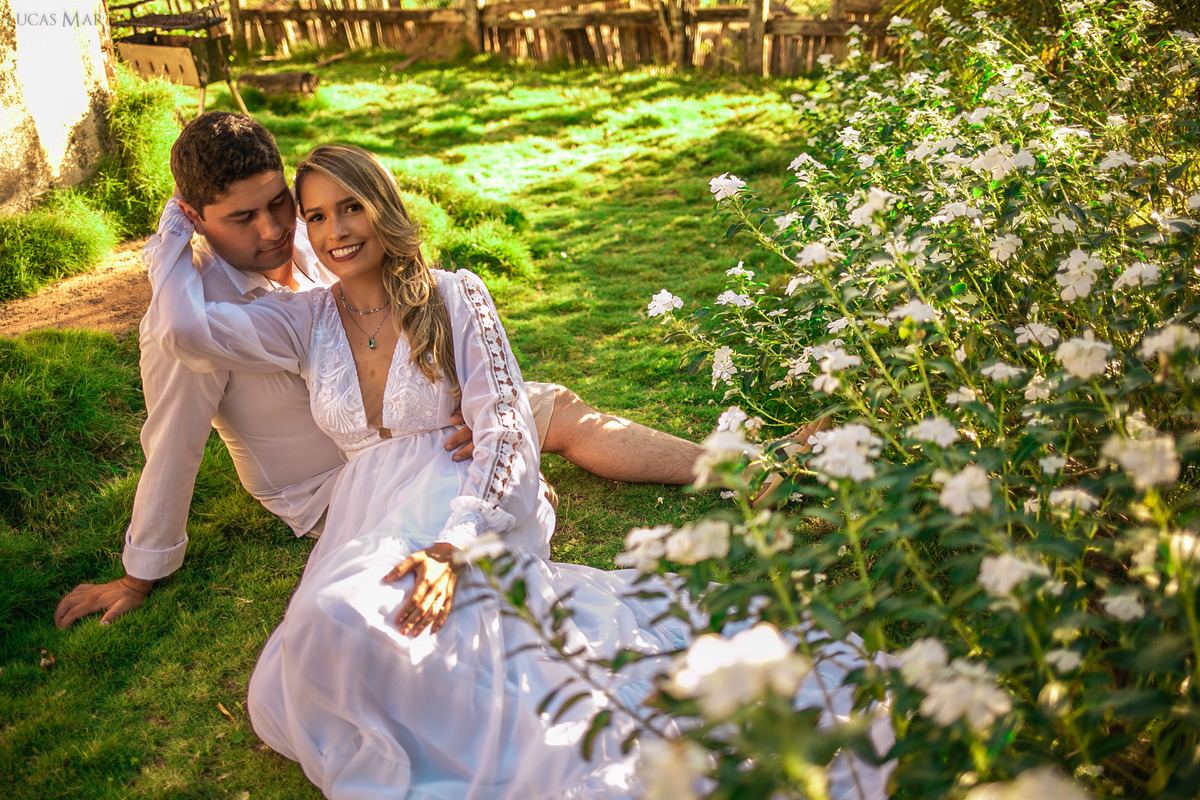 casal em gramado com flores brancas