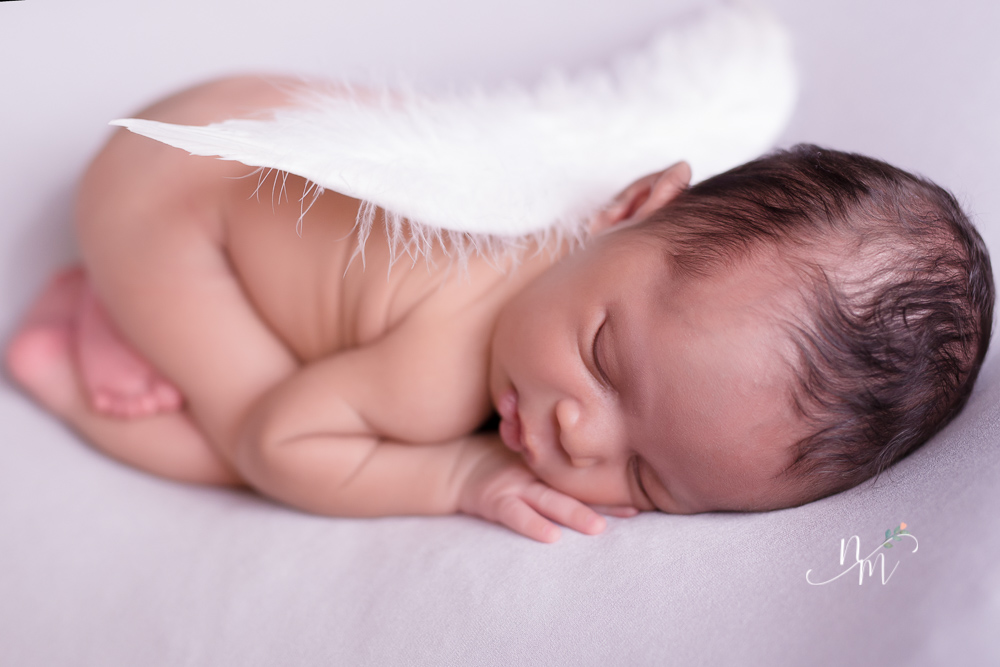foto de bebe recem nascido deitado com asa de ajinho