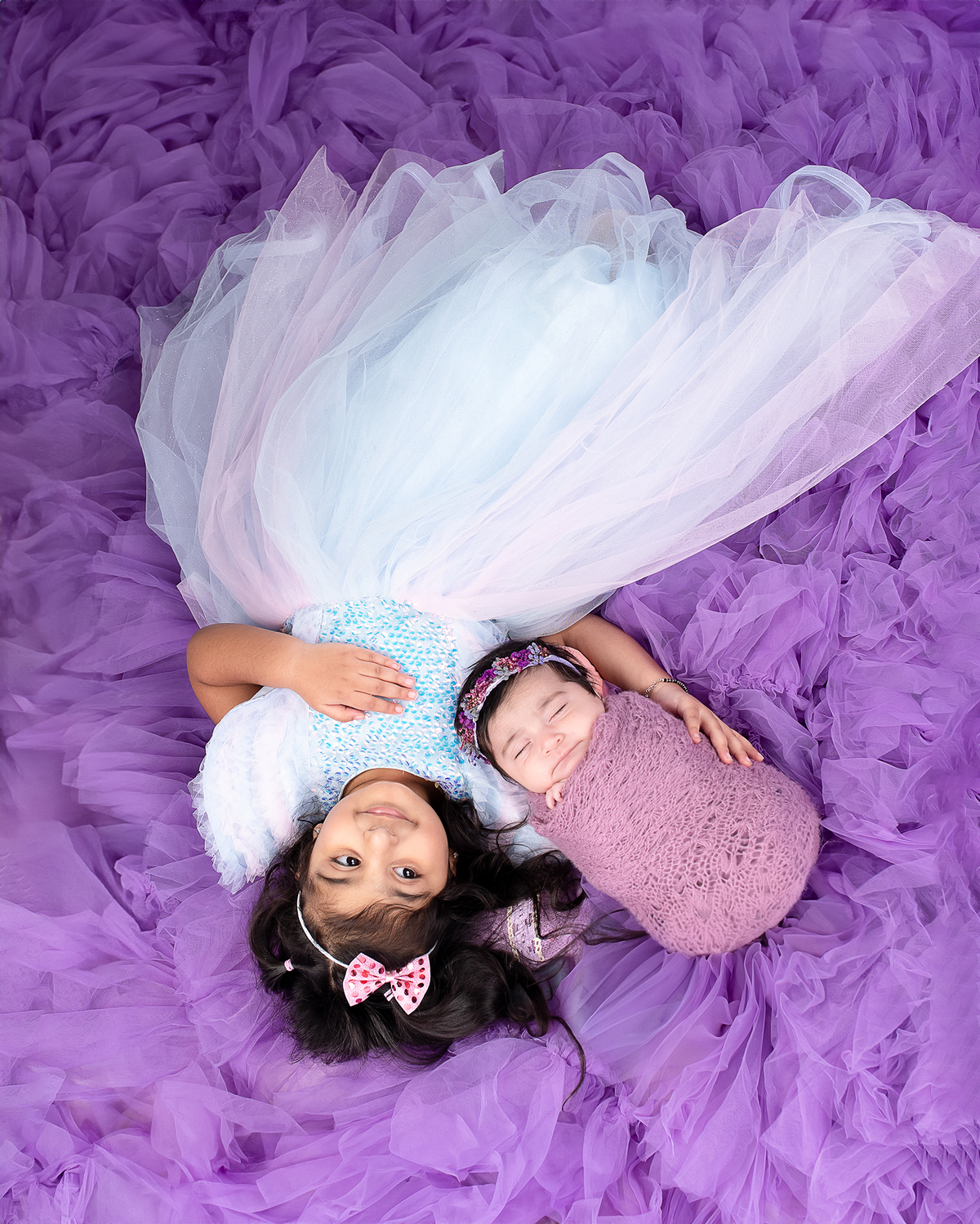 Newborn baby boy posed safely in father’s hands – Burnaby newborn photography studio