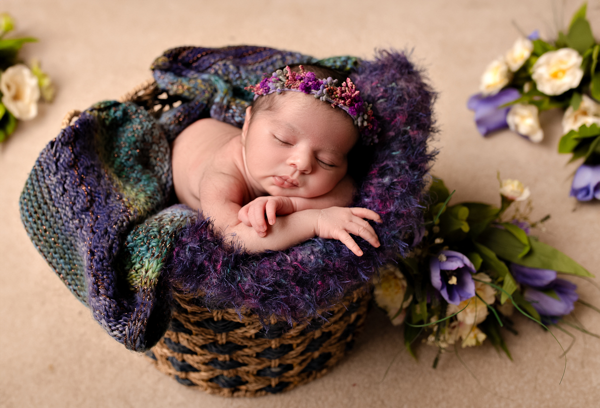 Newborn baby boy posed safely in father’s hands – Burnaby newborn photography studio