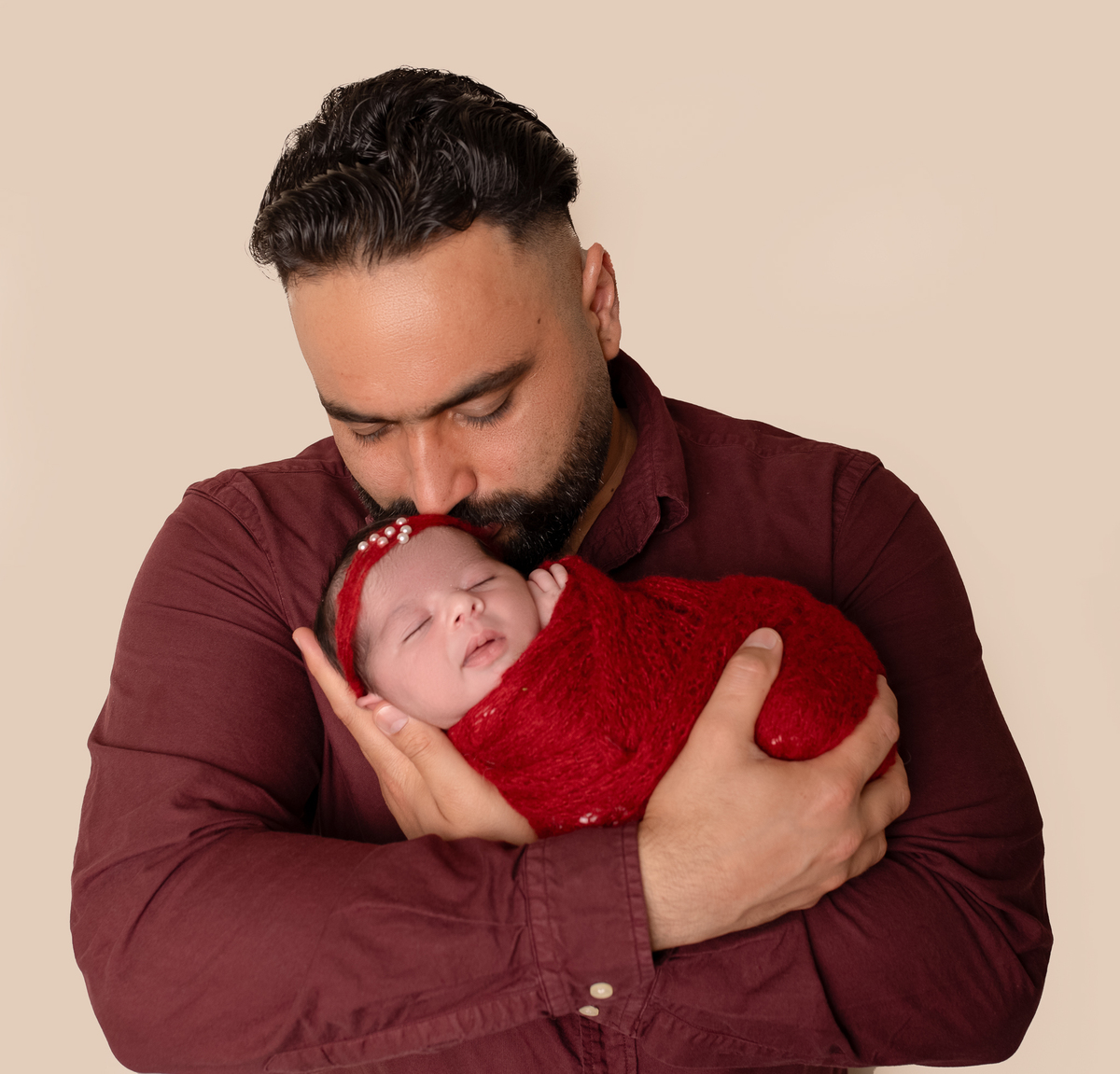 Newborn baby boy posed safely in father’s hands – Burnaby newborn photography studio