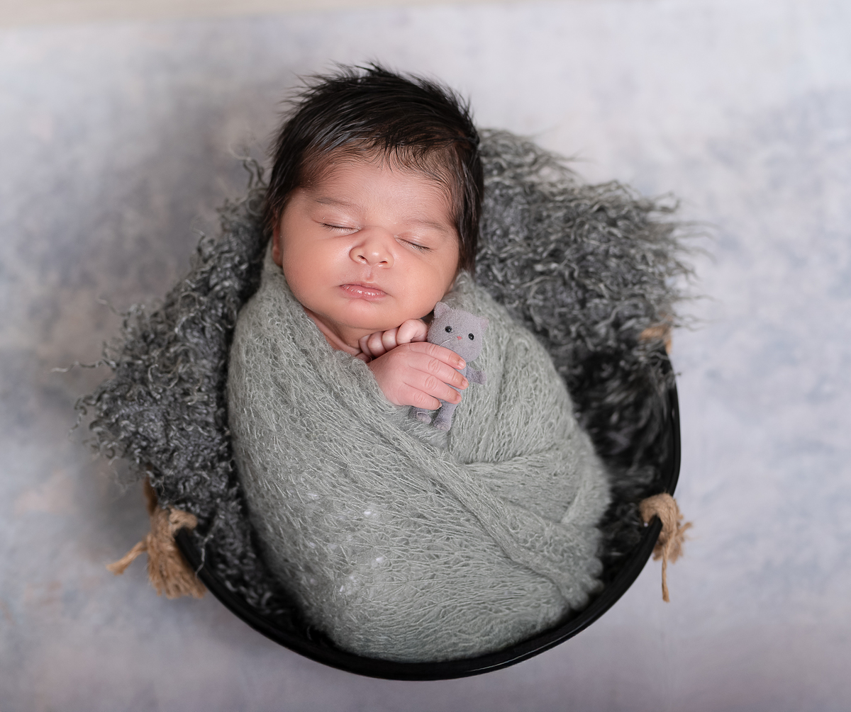 Newborn baby boy posed safely in father’s hands – Burnaby newborn photography studio